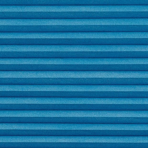 Blue pleated cellular window blind with horizontal textured folds, fully closed, evenly lit close-up view emphasizing fabric texture and shadowed ridges; no visible window or room context.