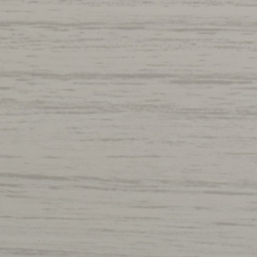 Light gray wood-grain panel with subtle horizontal streaks; lying flat and static, showing fine texture; close-up view of an evenly lit interior surface resembling laminate wall or tabletop.