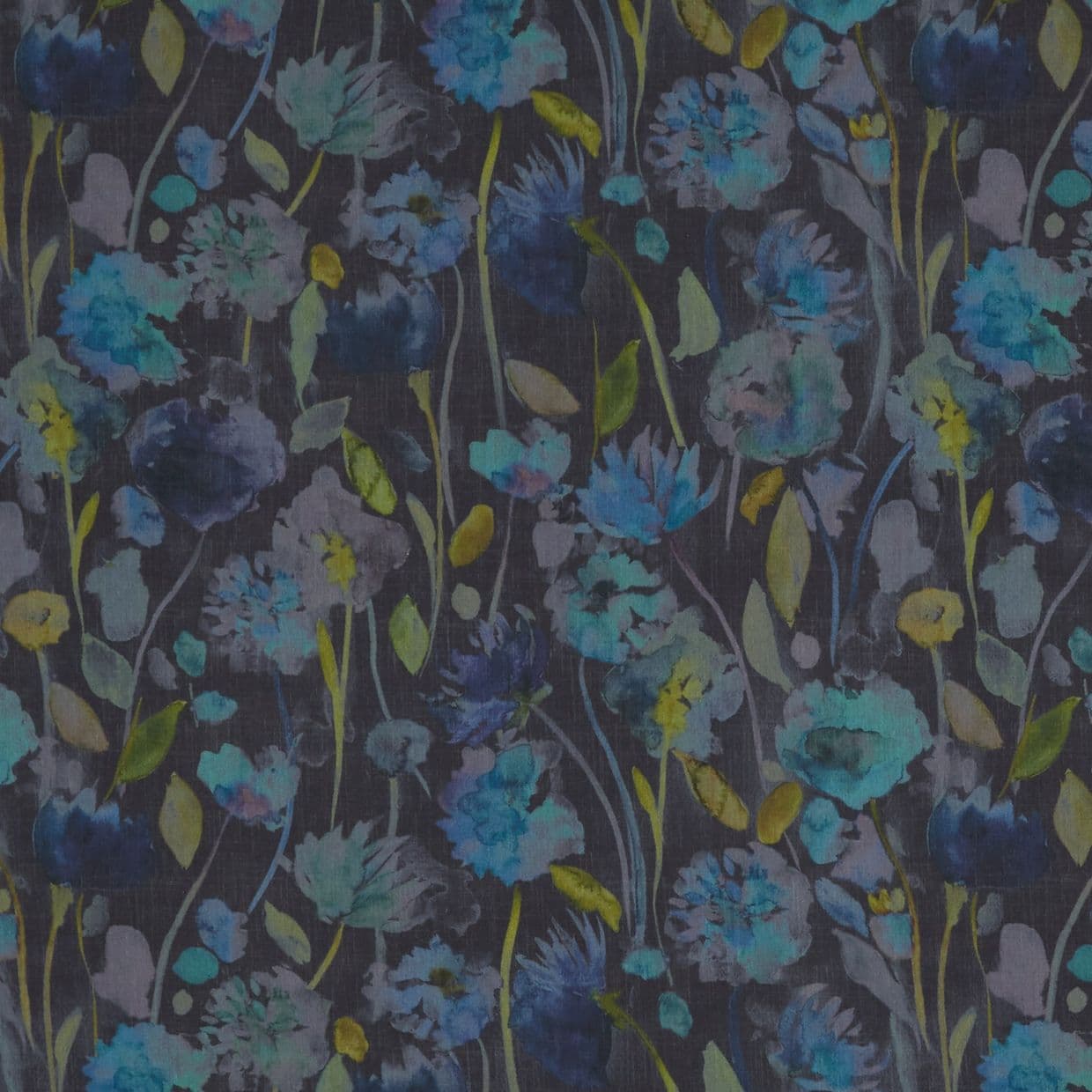 Floral fabric with watercolor-style blue and teal blossoms and slender green stems; pattern covers a dark charcoal surface, resembling wallpaper or curtain in soft, muted lighting.