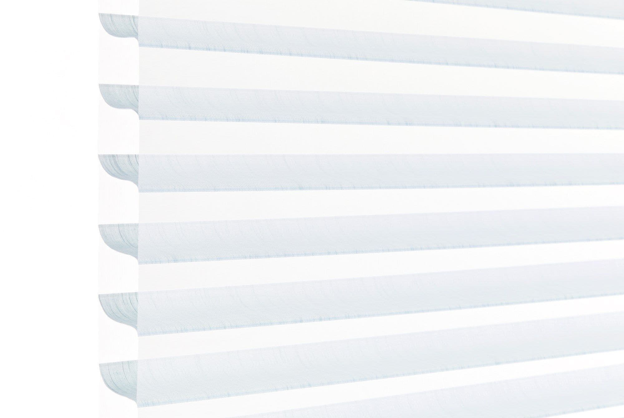 Layered horizontal zebra blindsâ€”alternating opaque white and sheer pale-blue bands with scalloped left edgeâ€”filtering soft daylight across a window, bright minimal interior with high-key lighting.
