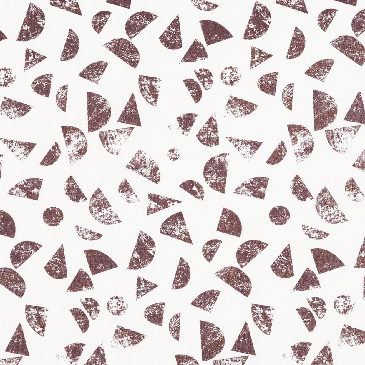 Distressed brown geometric shapes (half-circles, triangles, circles) stamped repeatedlyâ€”scattered across a white backgroundâ€”creating a loose, random repeating pattern with worn, textured prints.