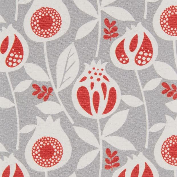 Wallpaper of stylized red-and-white pomegranate-like flowers and leaves, repeating across a textured grey surface; close-up crop with even studio lighting, no surrounding room visible.