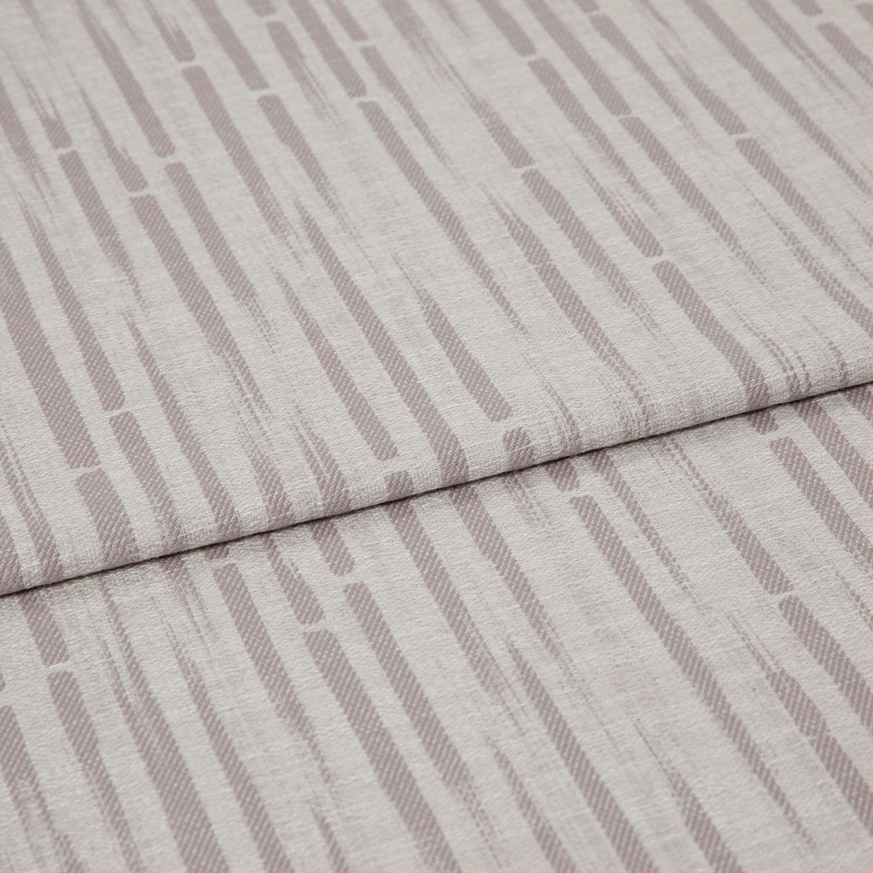 Patterned upholstery fabric (folded), pale mauve vertical dash stripes and textured weave; overlapping folded edge across the frame; close-up on a flat surface under soft, neutral lighting.