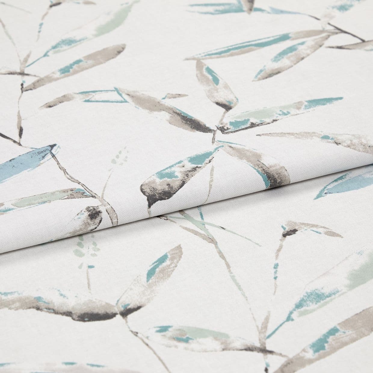 Folded white curtain fabric featuring pale teal and gray watercolor leaf print â€” folded to show pattern across layers â€” close-up, evenly lit studio product view.