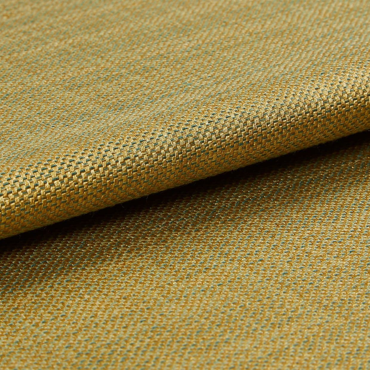 Woven upholstery fabric (gold and teal), small basket-weave pattern, folded over itself; viewed in a close-up macro shot, showing texture and subtle sheen under soft studio lighting.