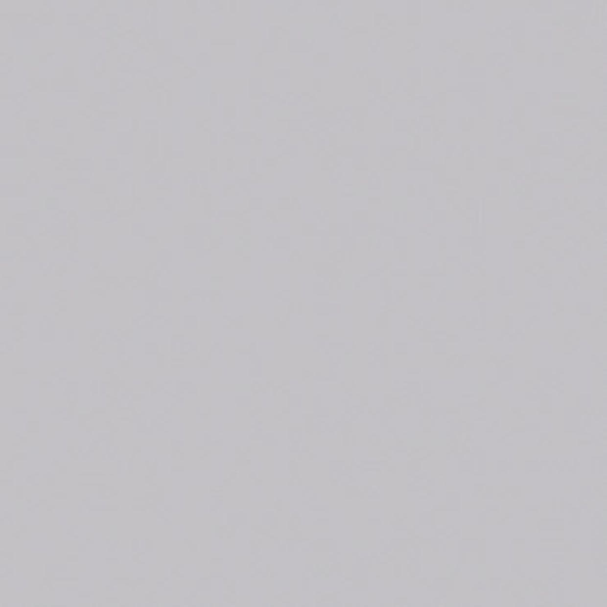 Light-gray smooth wall surface filling the entire frame; uniformly lit and featureless, showing no window dressings, fixtures, furniture, or other contextual details.