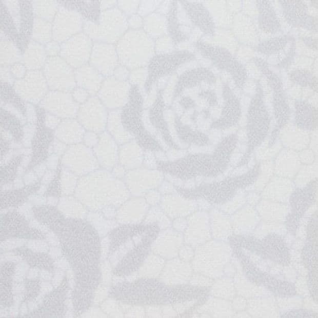 White lace-like fabric with rose and honeycomb motifs, showing an embossed floral pattern, presented in a tight close-up under soft, even diffuse lighting on a neutral background.