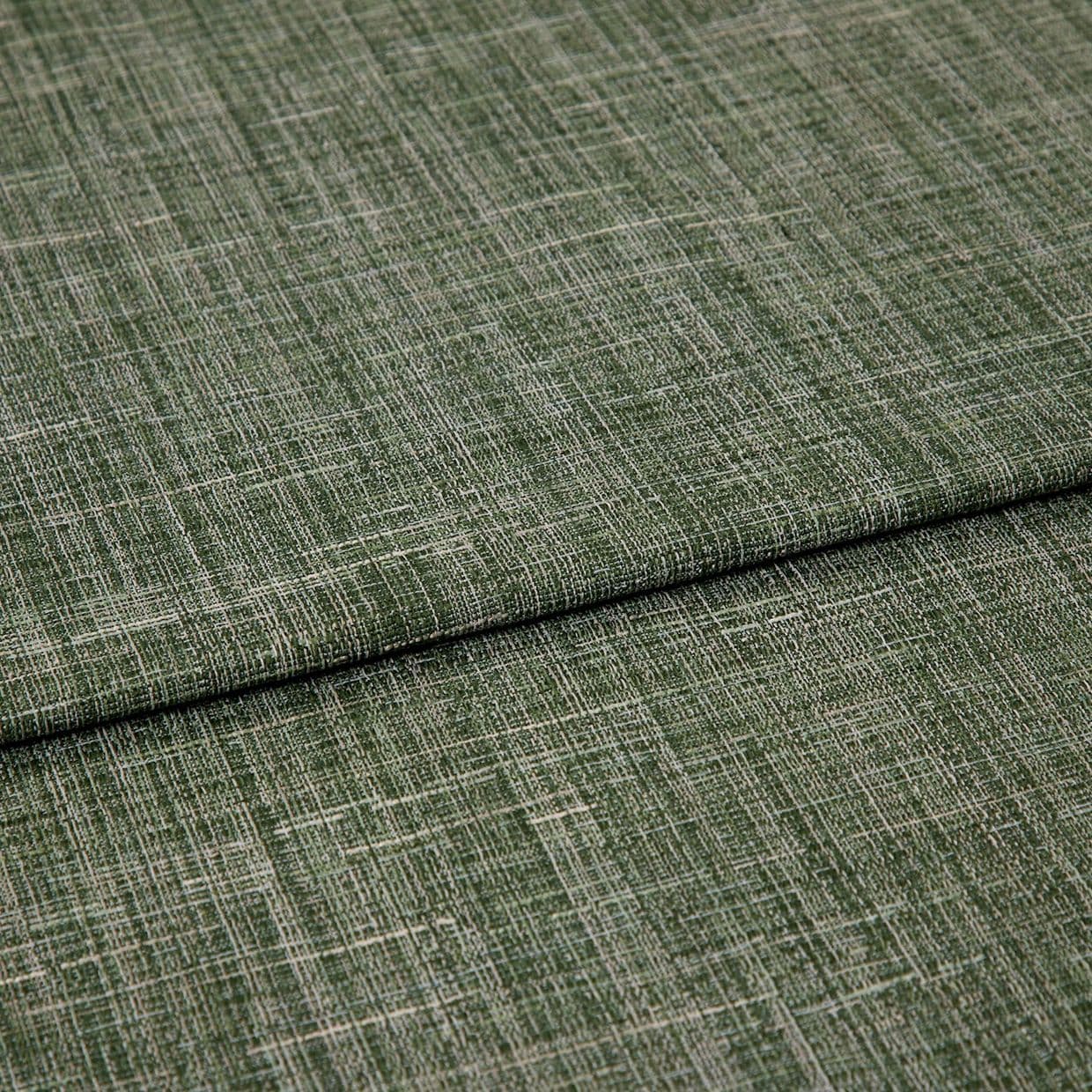Green crosshatched woven fabric, folded in overlapping layers, displaying textured beige and olive threads; tightly lit close-up emphasizing the weave and subtle sheen on a neutral surface.