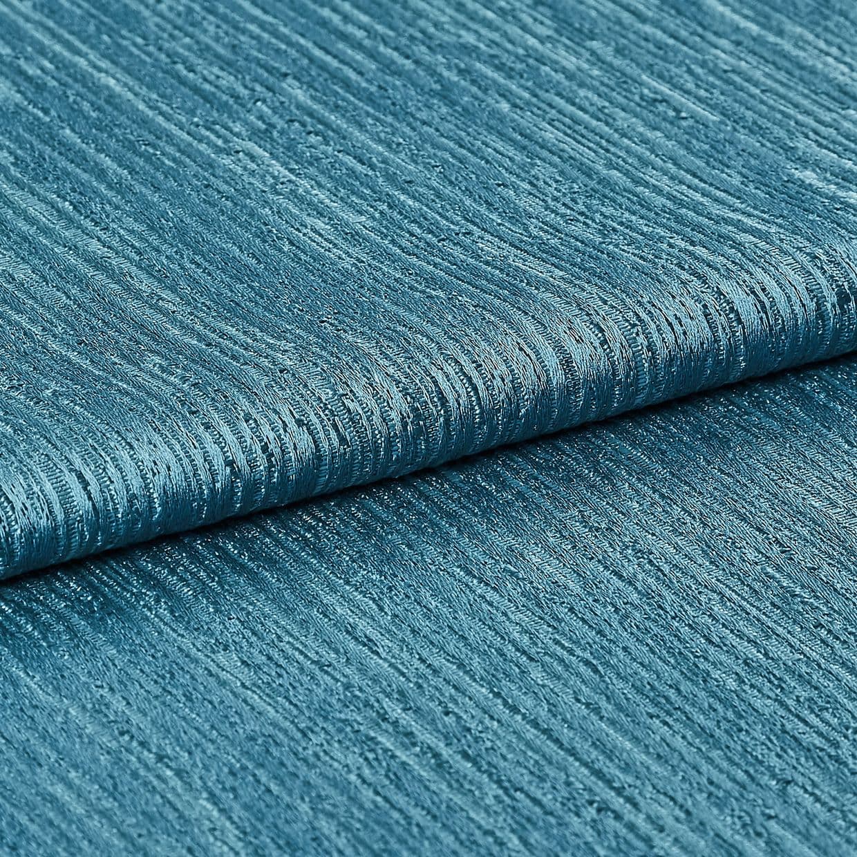 Teal ribbed fabric (folded), showing horizontal raised ridges and woven sheen; folded layers lie against each other in a close-up studio shot with even lighting, emphasizing texture and subtle metallic shimmer.
