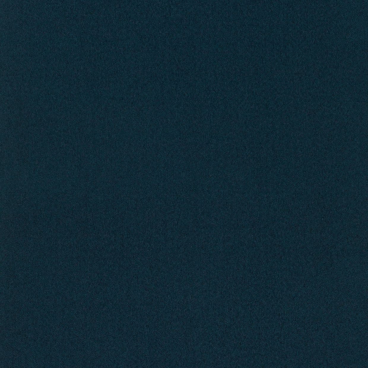 Dark teal, finely speckled surface fills the frame, uniformly lit and featureless, resembling low-light digital noise or coarse fabric.