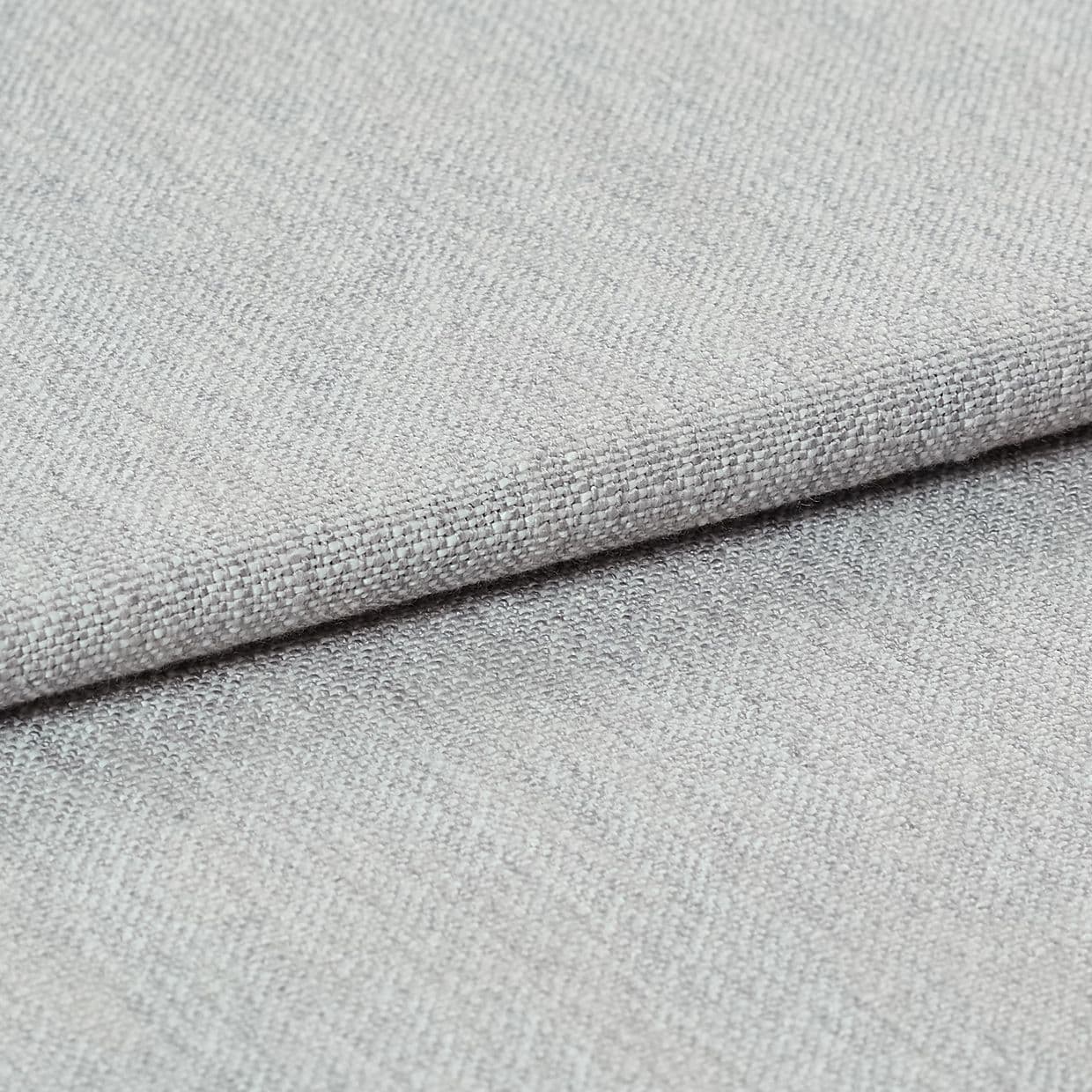 Light gray woven fabric, folded with a visible hem edge across the frame; tightly textured weave and subtle nap; close-up studio-lit shot on a neutral surface, soft even lighting.