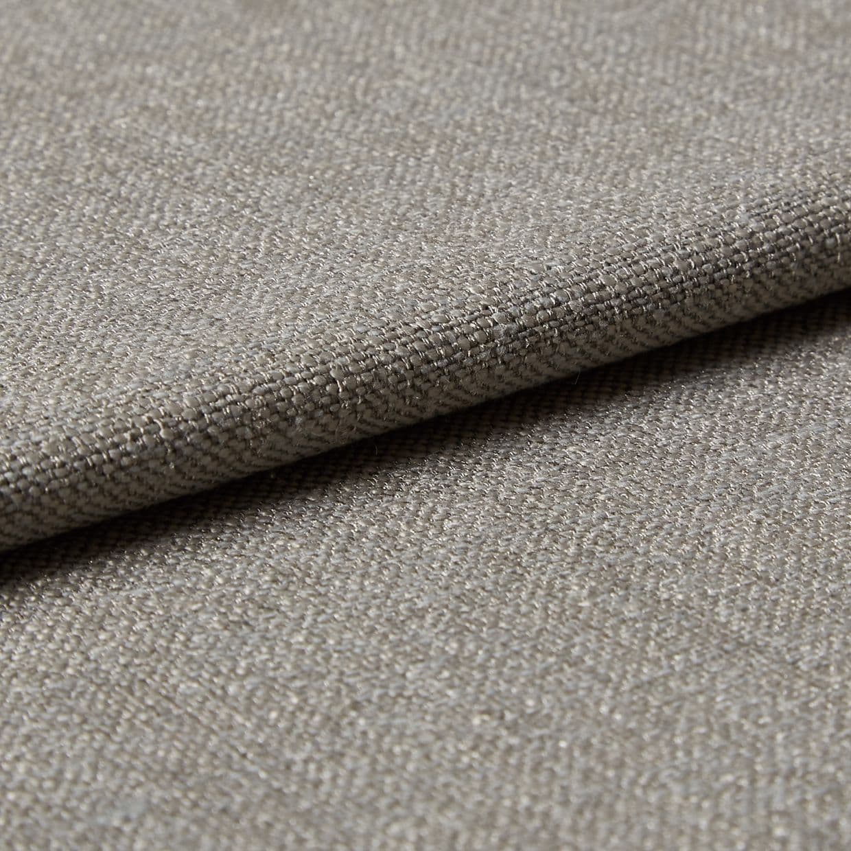 Beige woven fabric folded over itself, showing a tight basket-weave texture; lying flat in soft, neutral lighting, close-up view emphasizing threads and subtle sheen.