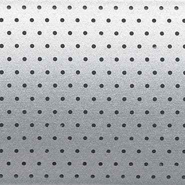 Perforated aluminum panel with evenly spaced round holes in a regular grid; serving as a vent or acoustic grille; shown under soft, diffuse lighting producing a subtle top-to-bottom gradient.