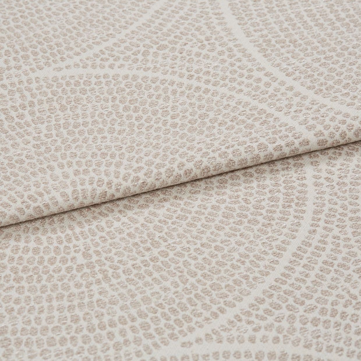 Beige textured fabric with pebbleâ€‘like raised dots and subtle curved lines; folded horizontally across the frame; close-up studio shot showing layered upholstery material in even, soft lighting.