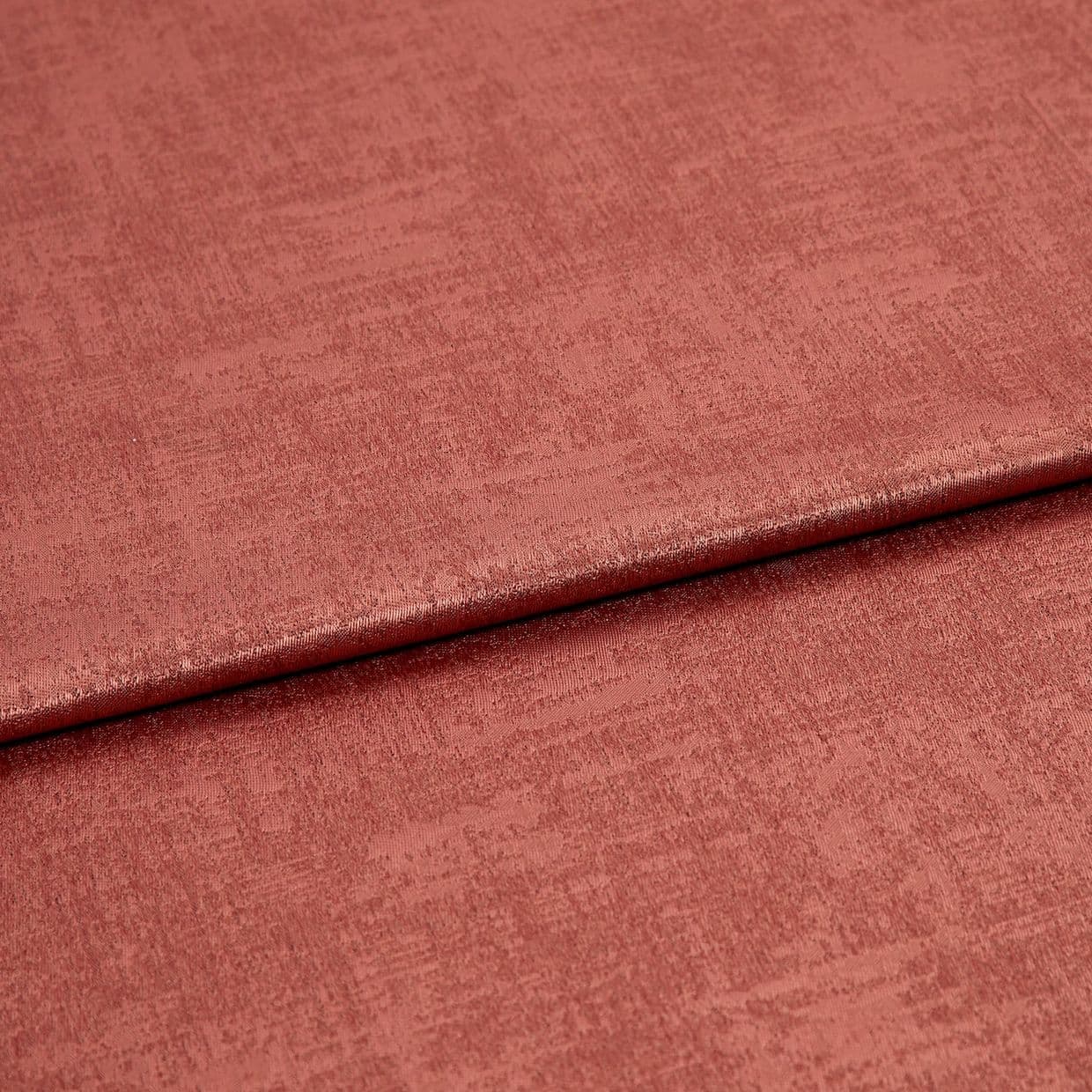 Folded roseâ€‘colored textured fabric, a soft velvet-like material with a horizontal overlap fold; lit evenly in a close-up studio view showing subtle sheen and woven surface detail.