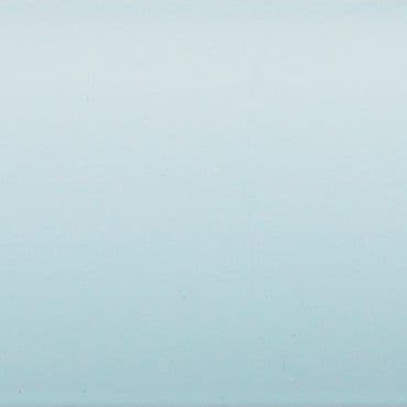 Pale blue painted wall occupying the frame, showing faint texture and a subtle vertical gradient, evenly lit and softly reflecting light in a minimal, featureless interior.