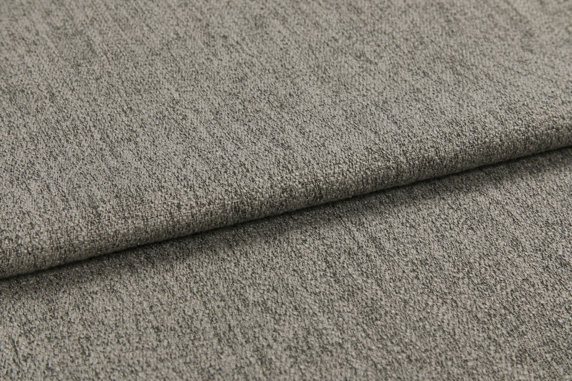 Gray textured upholstery fabric, folded once with a visible crease, lying flat; soft looped weave surface; close-up macro view with neutral diffuse lighting and no background context.