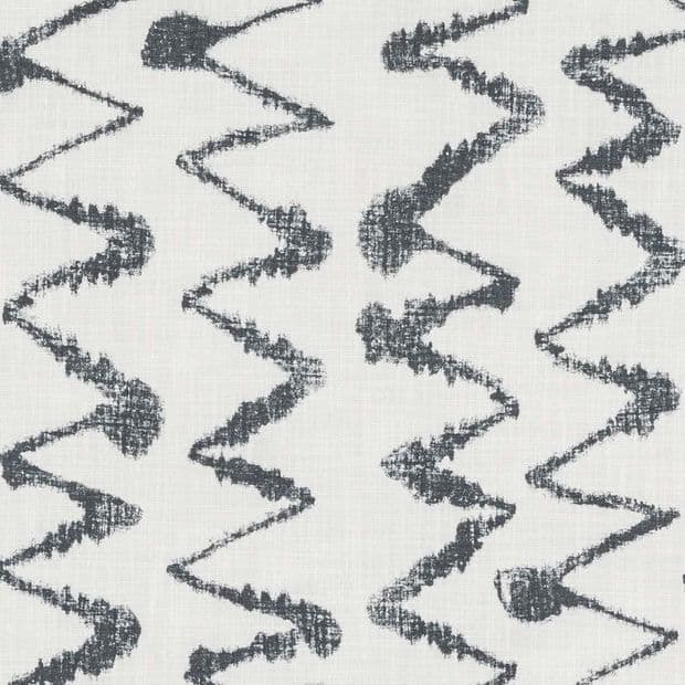 Light woven fabric displaying vertical columns of charcoal, irregular zigzag brushstroke lines; pattern repeats across the surface, suggesting upholstery or drapery material in a neutral, evenly lit close-up.
