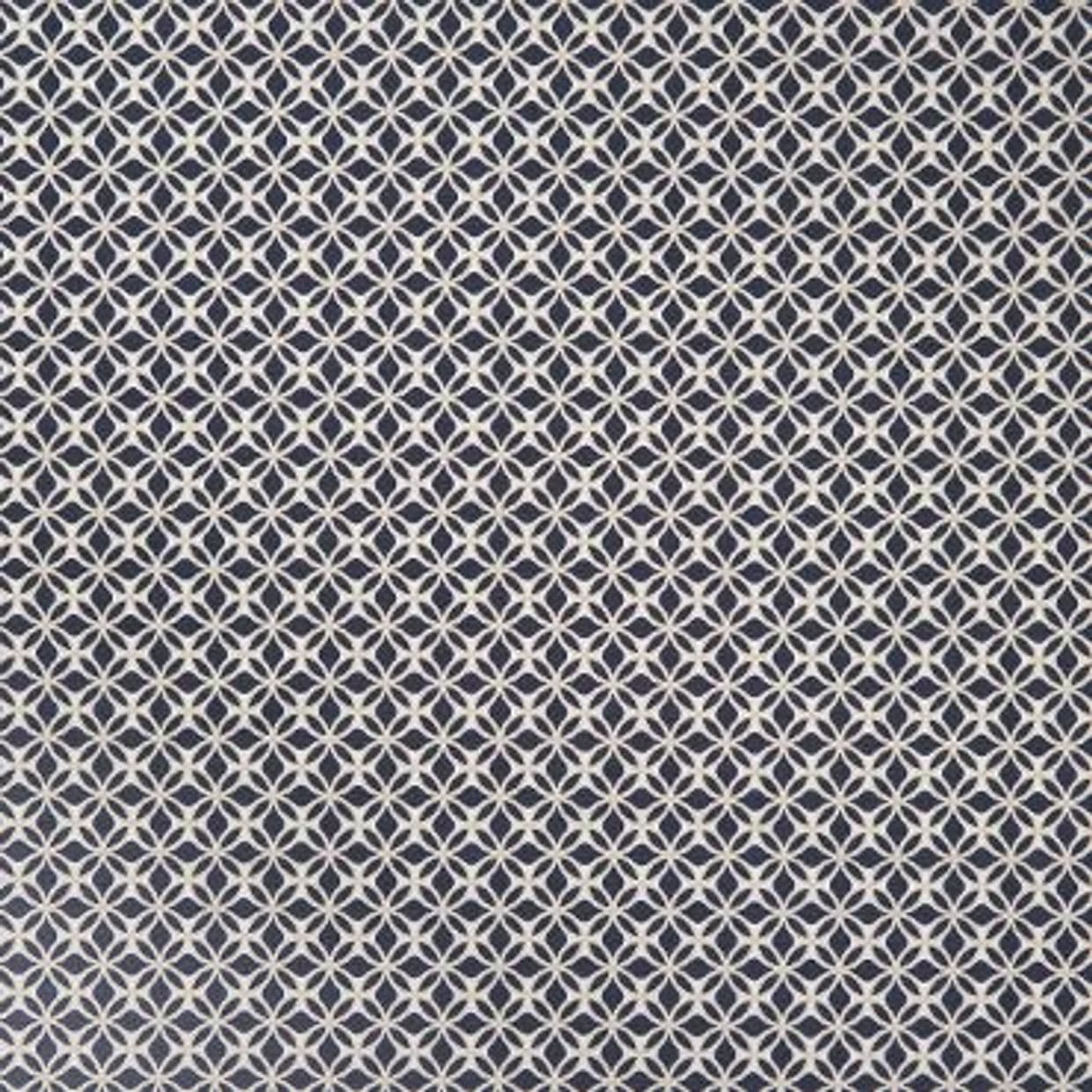 White interlocking circular-lattice pattern on navy fabric; repeating tessellated motif covering the entire surface; appears as flat wallpaper or upholstery in even, diffuse interior lighting.