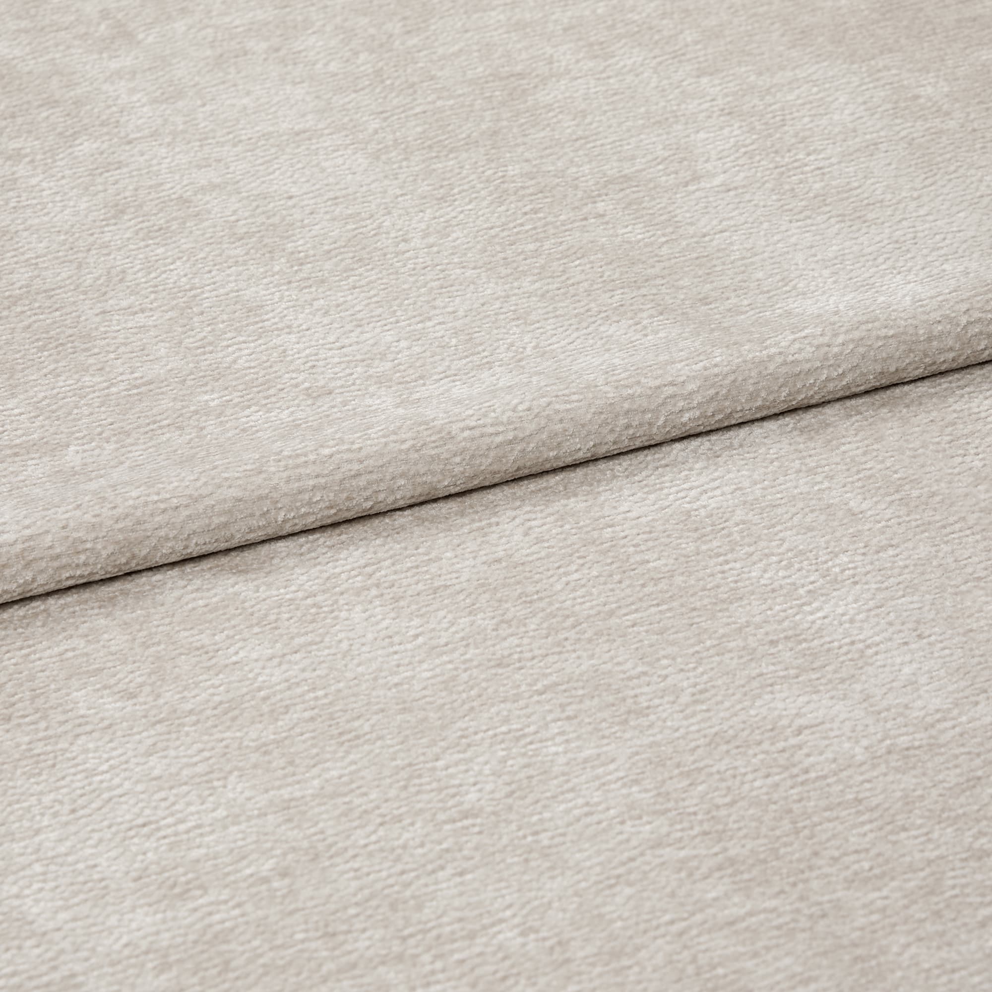 Beige textured fabric, folded with a horizontal overlap; soft, slightly napped surface; close-up, evenly lit view of neutral upholstery or drapery textile.