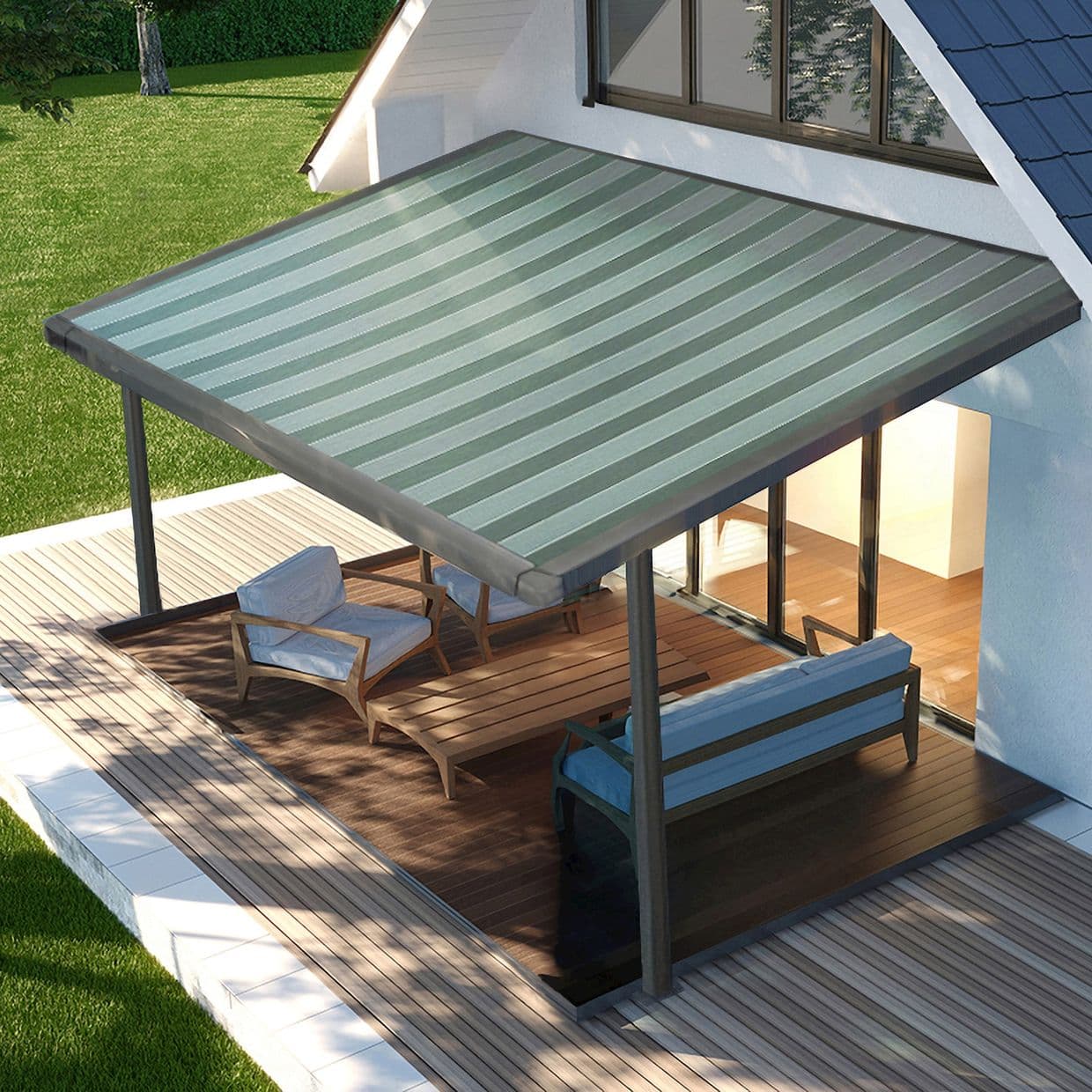 Striped green-gray retractable awning, mounted above sliding glass doors and supported by metal posts, shading and softly filtering sunlight over a wooden deck patio with lounge seating and lawn.