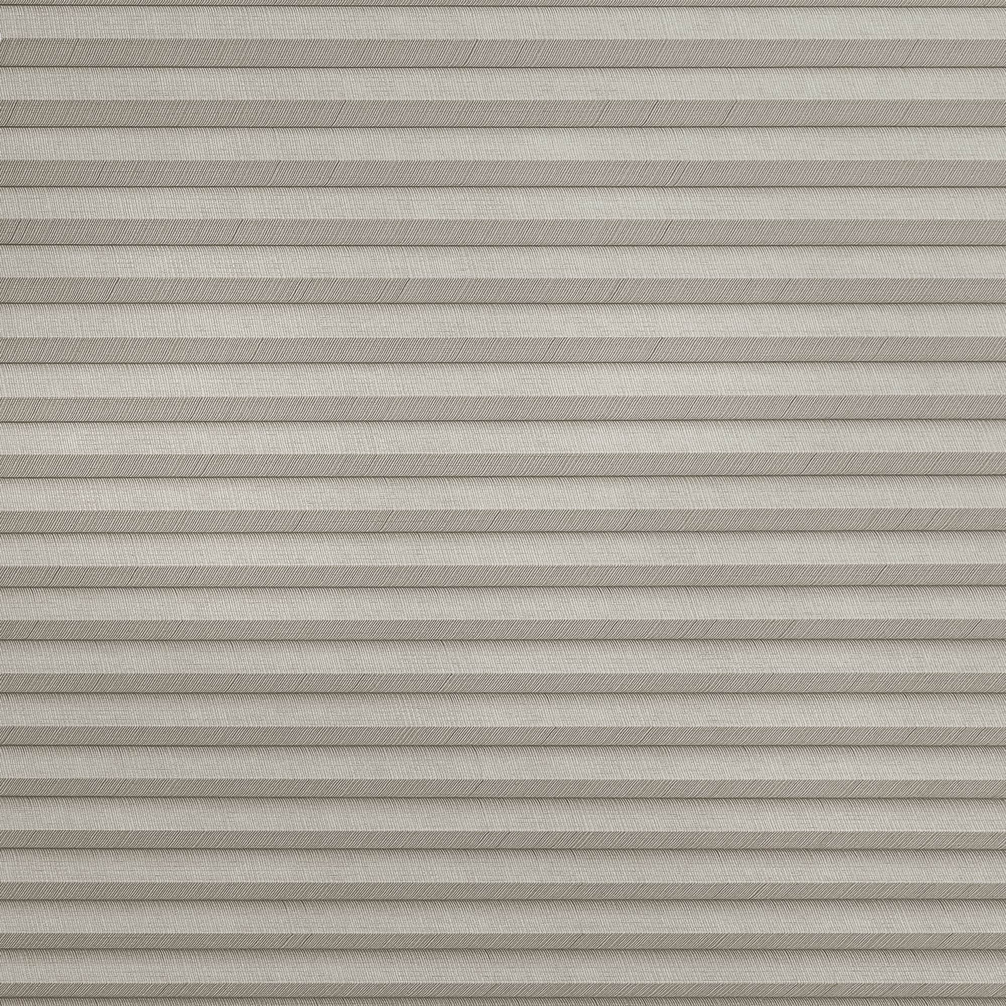 Beige pleated cellular blinds with subtle herringbone weave, fully lowered and closed, softly diffusing light while covering a window in a neutral, evenly lit interior.