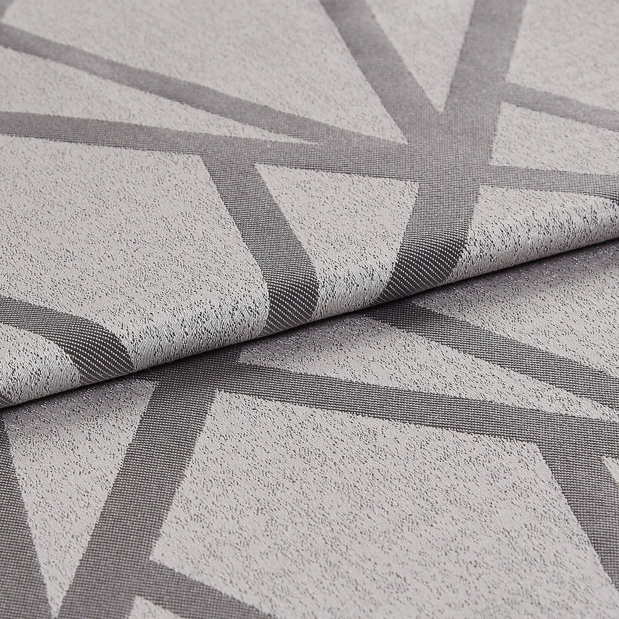 Textured light-grey fabric with dark-grey intersecting geometric bands (raised weave), folded once to reveal the edge; close-up studio-lit view highlighting weave, pattern and subtle sheen on a neutral surface.