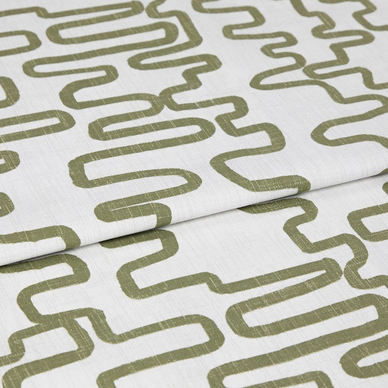 White linen-like fabric with olive-green meandering rectangular print, folded in layers, shown as a close-up textile sample on a neutral background under soft, even studio lighting.