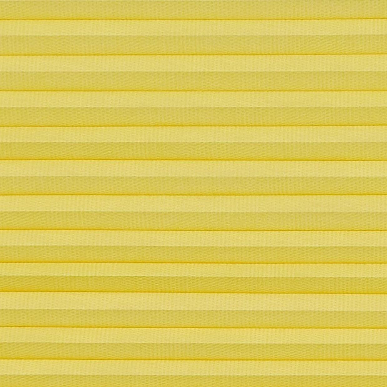 Yellow pleated cellular blind spanning the frame, horizontal accordion folds with textured fabric; fully lowered and closed, softly diffusing light in a neutral, evenly lit interior close-up with no visible view.