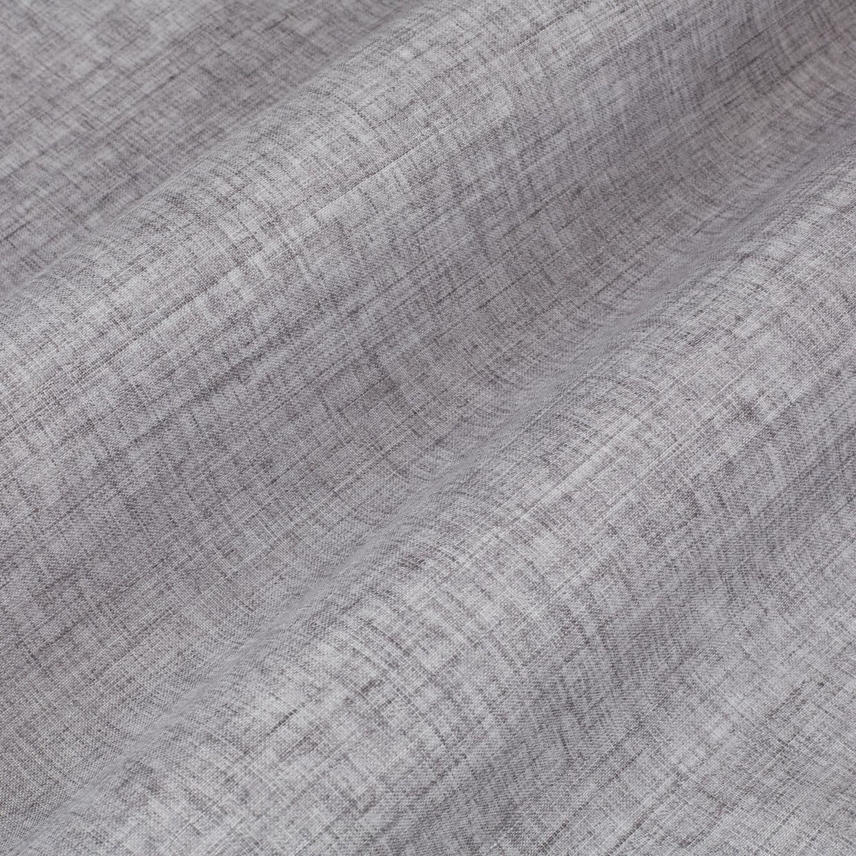 Grey textured curtain fabric, linen-like, draped in gentle vertical folds, showing a crosshatch weave; soft light highlights subtle shading and texture in a close-up studio setting.