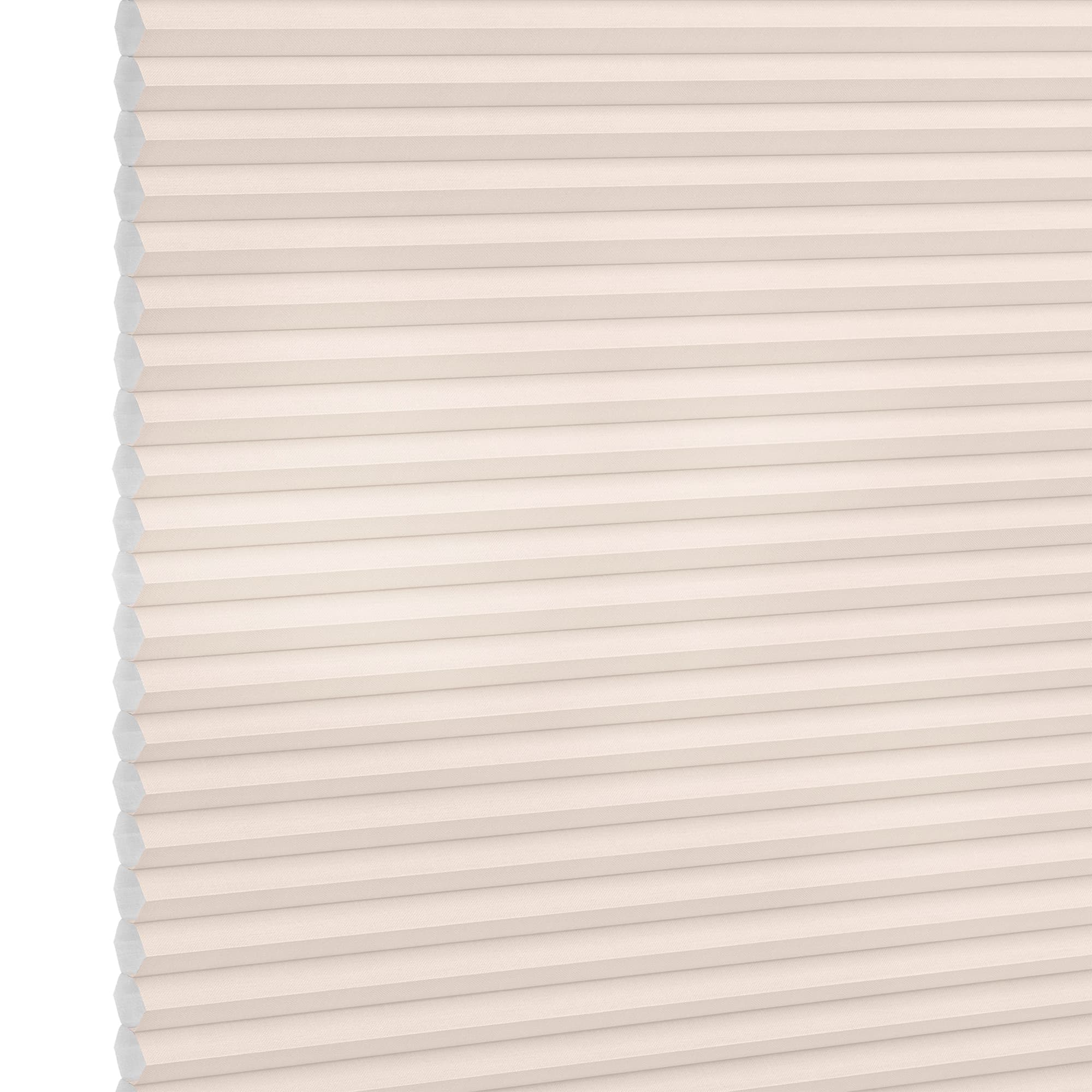 Cellular (honeycomb) pleated blind, cream-colored, fully lowered and closed with visible hexagonal cells; diffusing soft light across a plain interior wall, suggesting a bright, neutral room.