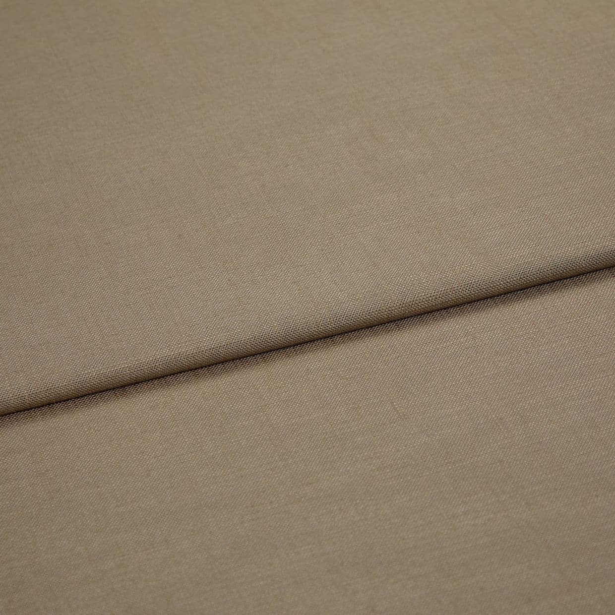 Beige woven fabric panel (textured) with a pronounced horizontal fold, folded over itself; close-up view showing fine weave, even neutral lighting and no visible surroundings.