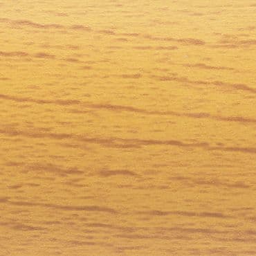 Close-up of a golden-toned horizontal wood-grain surface, displaying subtle darker striations; static, evenly lit and tightly framed with no other objects or visible depth cues.