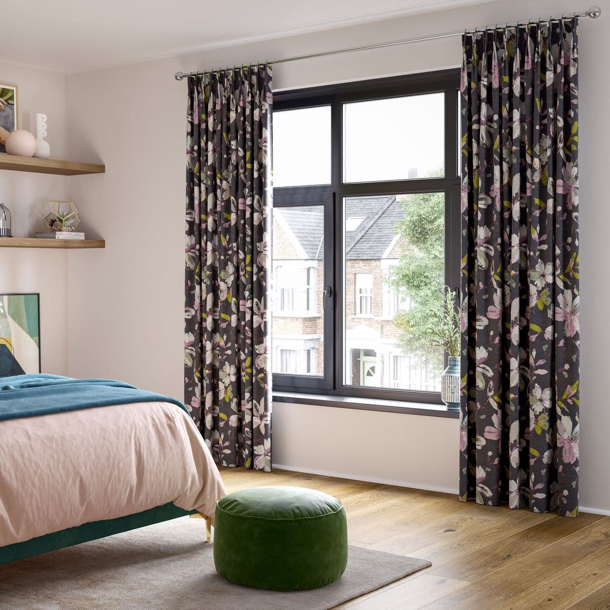 Floral-patterned pleated curtains, pulled to either side and framing a black-framed casement window, filtering bright daylight into a modern bedroom with wooden floor, bed and green round pouf.