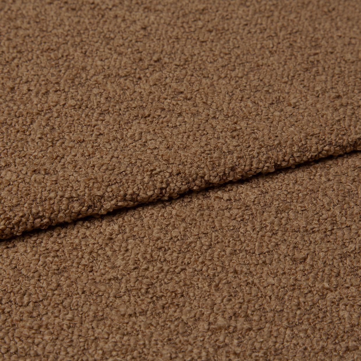 Brown looped bouclÃ© fabric, folded with an overlapping edge; fold casts a shallow shadow; close-up textile sample in even soft lighting, emphasizing dense, nubby pile texture.