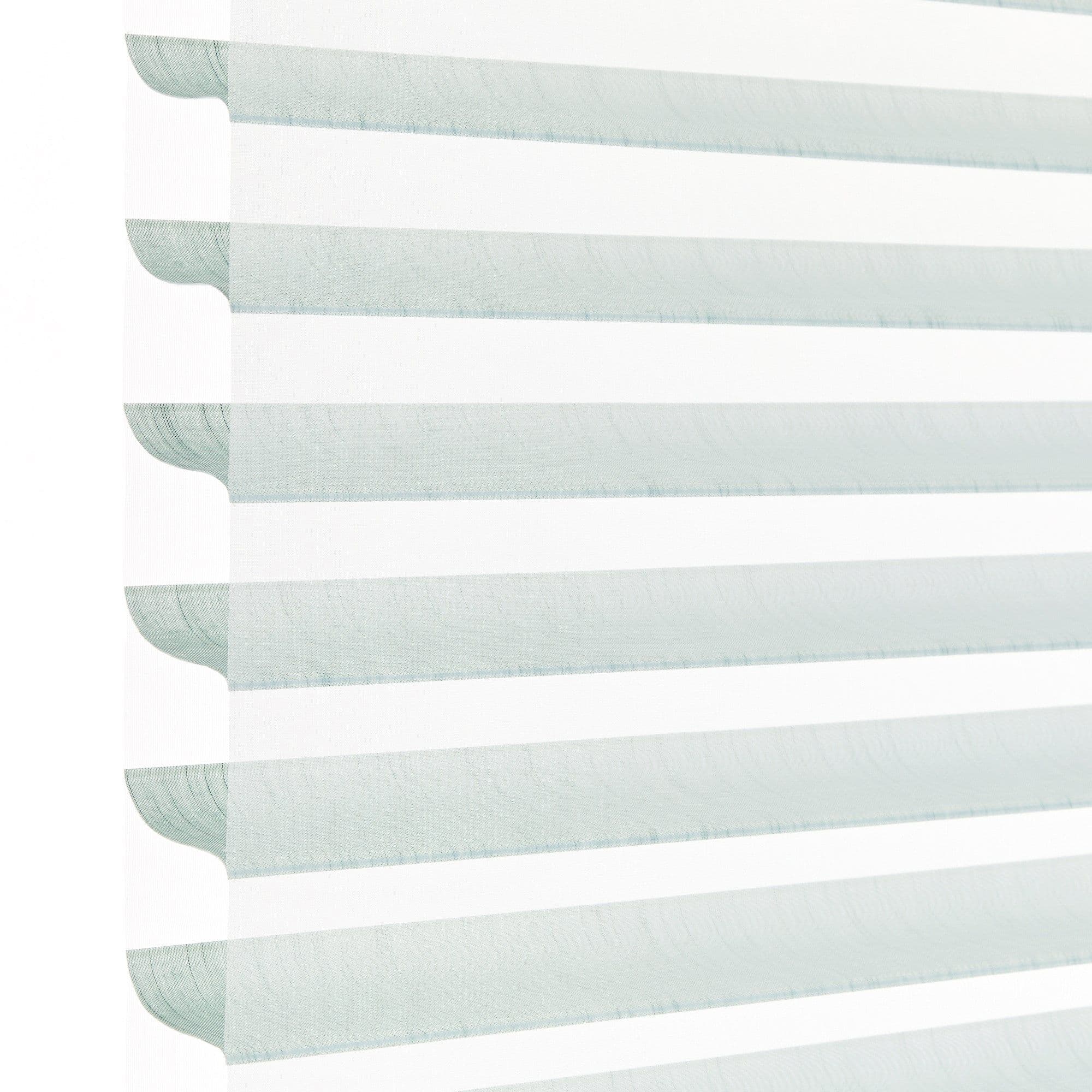 Layered horizontal zebra blind with alternating pale aqua translucent and opaque white fabric stripes, hanging lowered; filtering daylight and softly diffusing light in a bright, minimal indoor setting.