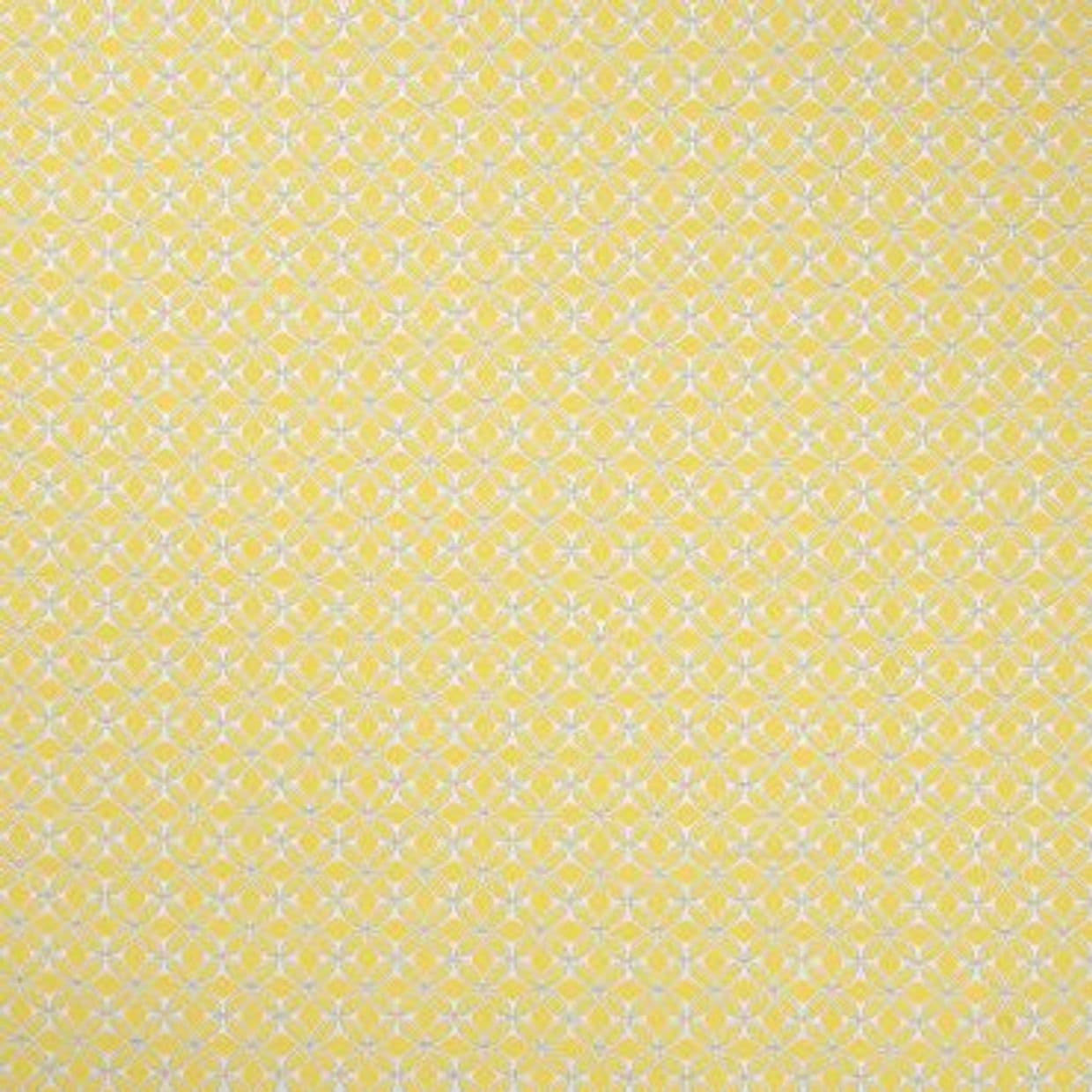 Pale yellow wallpaper with a dense white quatrefoilâ€‘flower lattice (object), covering a flat wall continuously (action), close-up interior view, evenly lit, no other features visible (context).