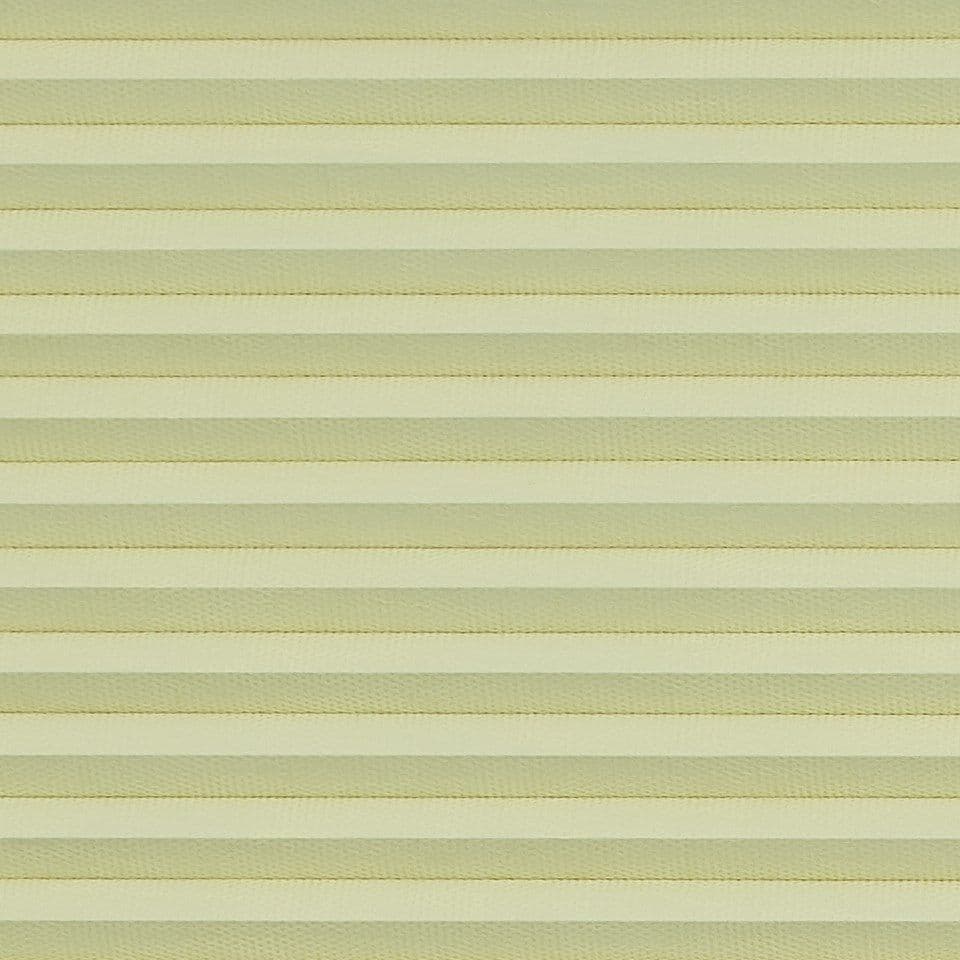 Honeycomb cellular blind with horizontal pleats, fully lowered and closed, diffusing soft daylight; close-up interior view showing uniform pale-yellow bands filling the frame.