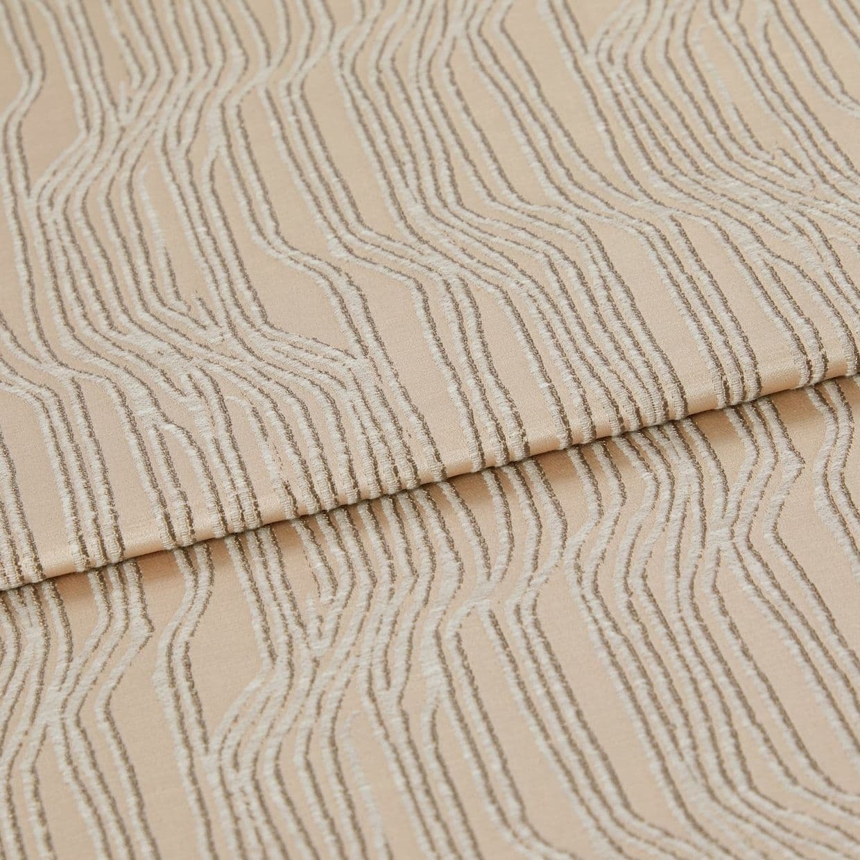 Beige textured fabric with raised, irregular wavy stripesâ€”folded once across the middleâ€”close-up view of a textile sample under soft, neutral studio lighting.
