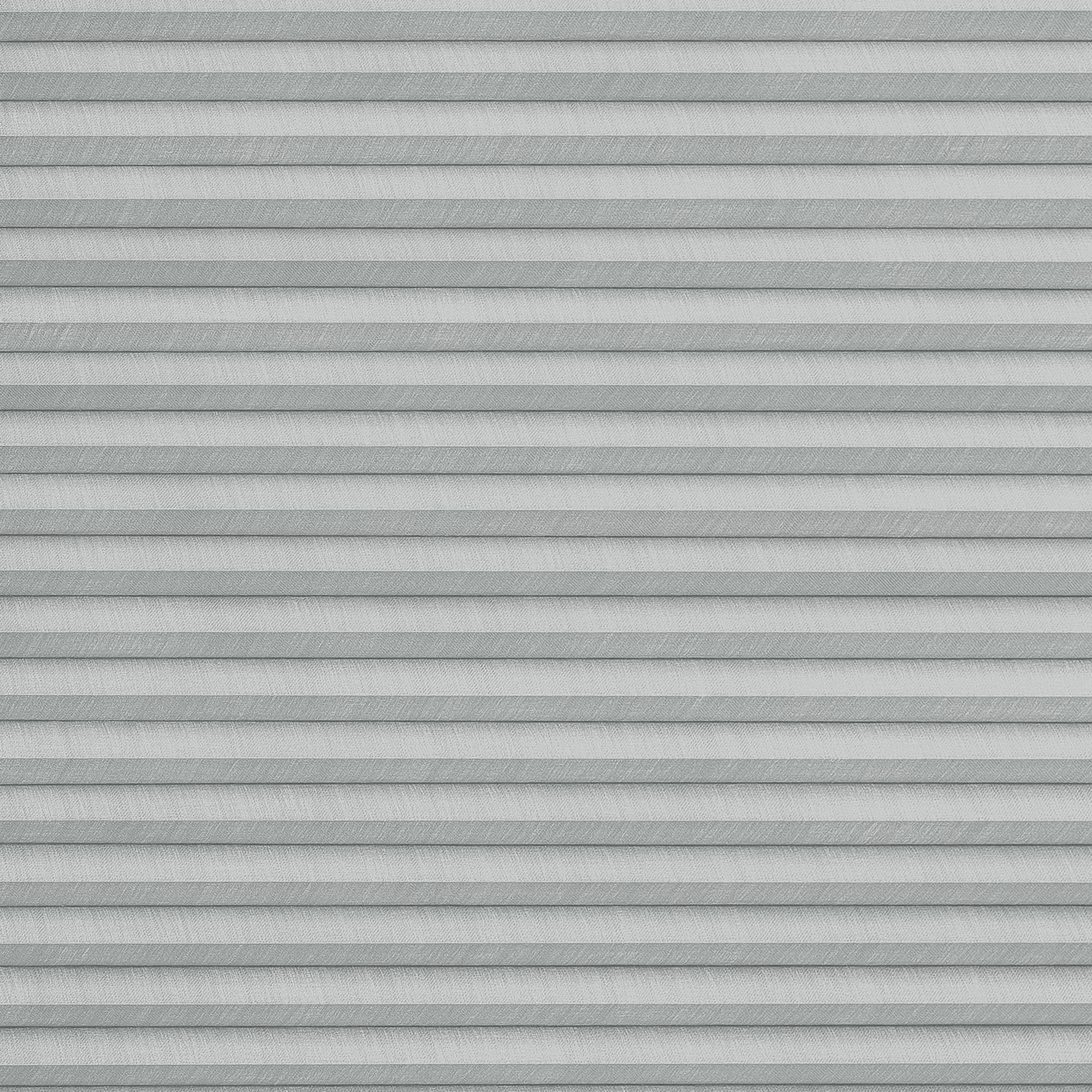 Gray pleated cellular blinds, fully lowered with horizontal fabric cells and subtle texture; closed and filtering diffuse daylight; covering an interior window in a softly lit room, no view visible.