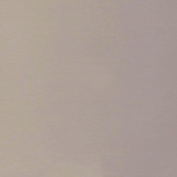 Plain light beige painted wall with subtle texture, filling the frame and evenly lit; minimal indoor setting with soft diffuse lighting and no visible fixtures or decorations.