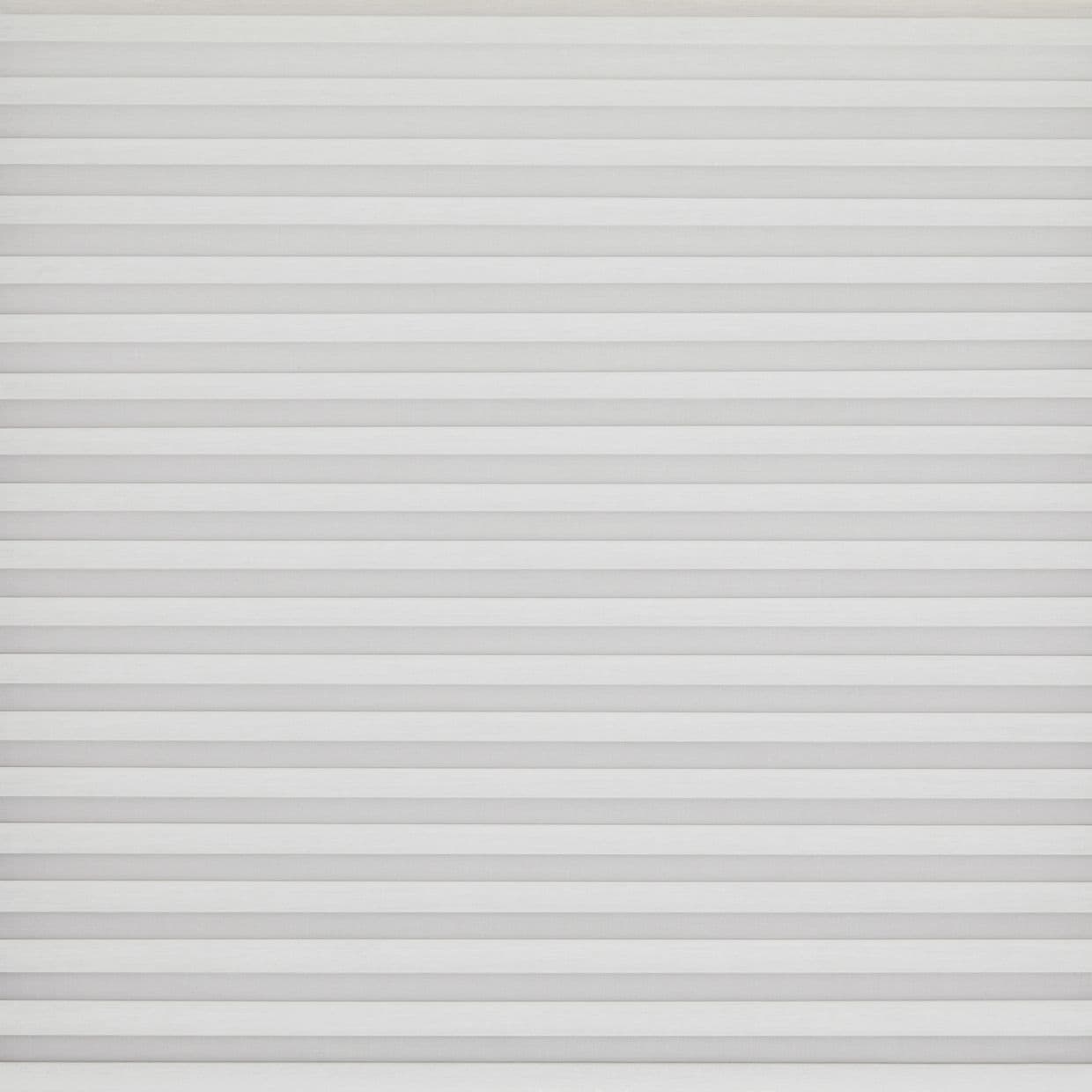 White horizontal pleated blinds covering the entire window, narrow evenly spaced slats; closed and softly diffusing daylight; set against a neutral wall in a bright, minimal interior.
