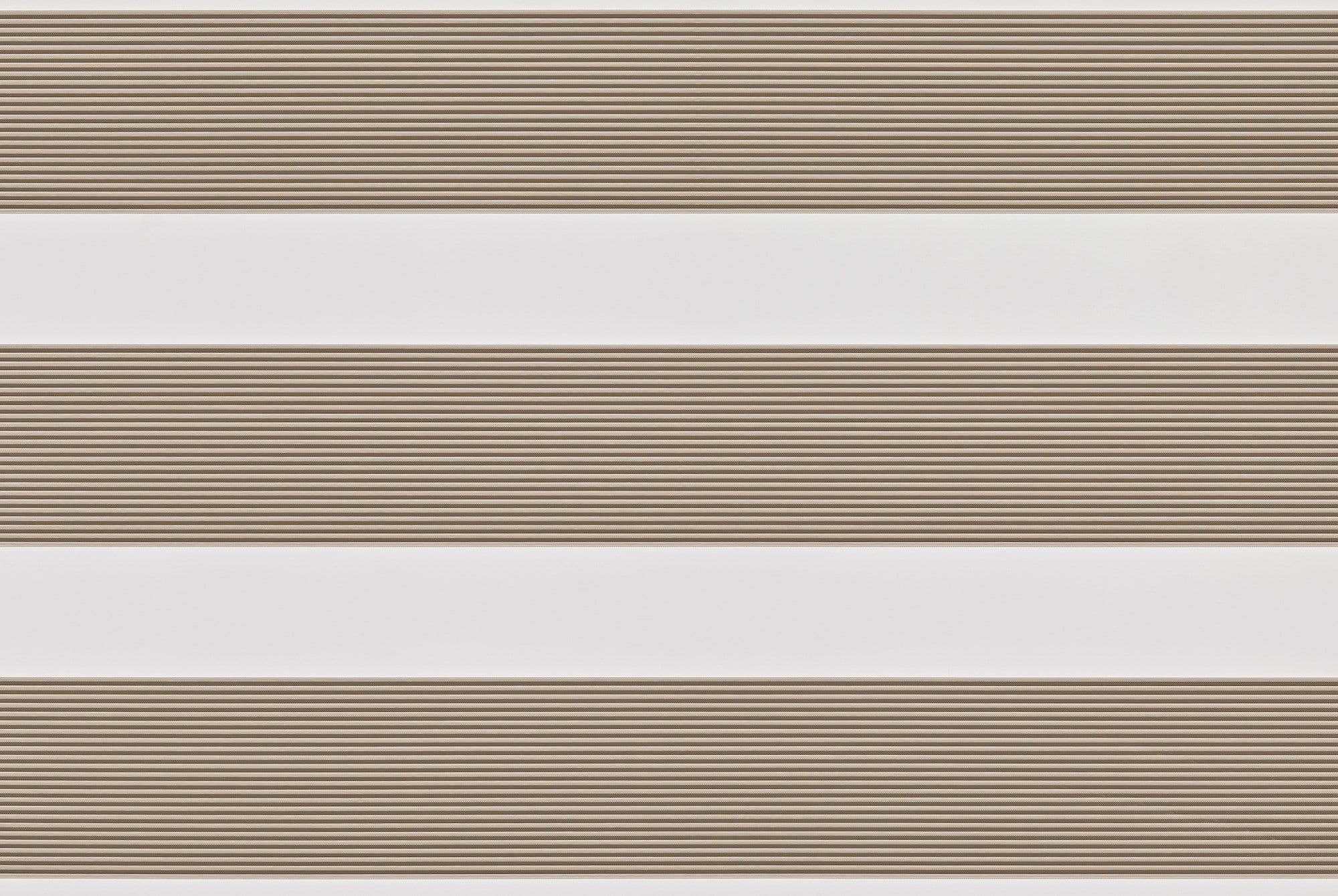 Dual-layer zebra roller blind lowered, alternating beige textured slats and white sheer bands; partially filtering light across a neutral interior wall, producing soft, evenly diffused daylight.