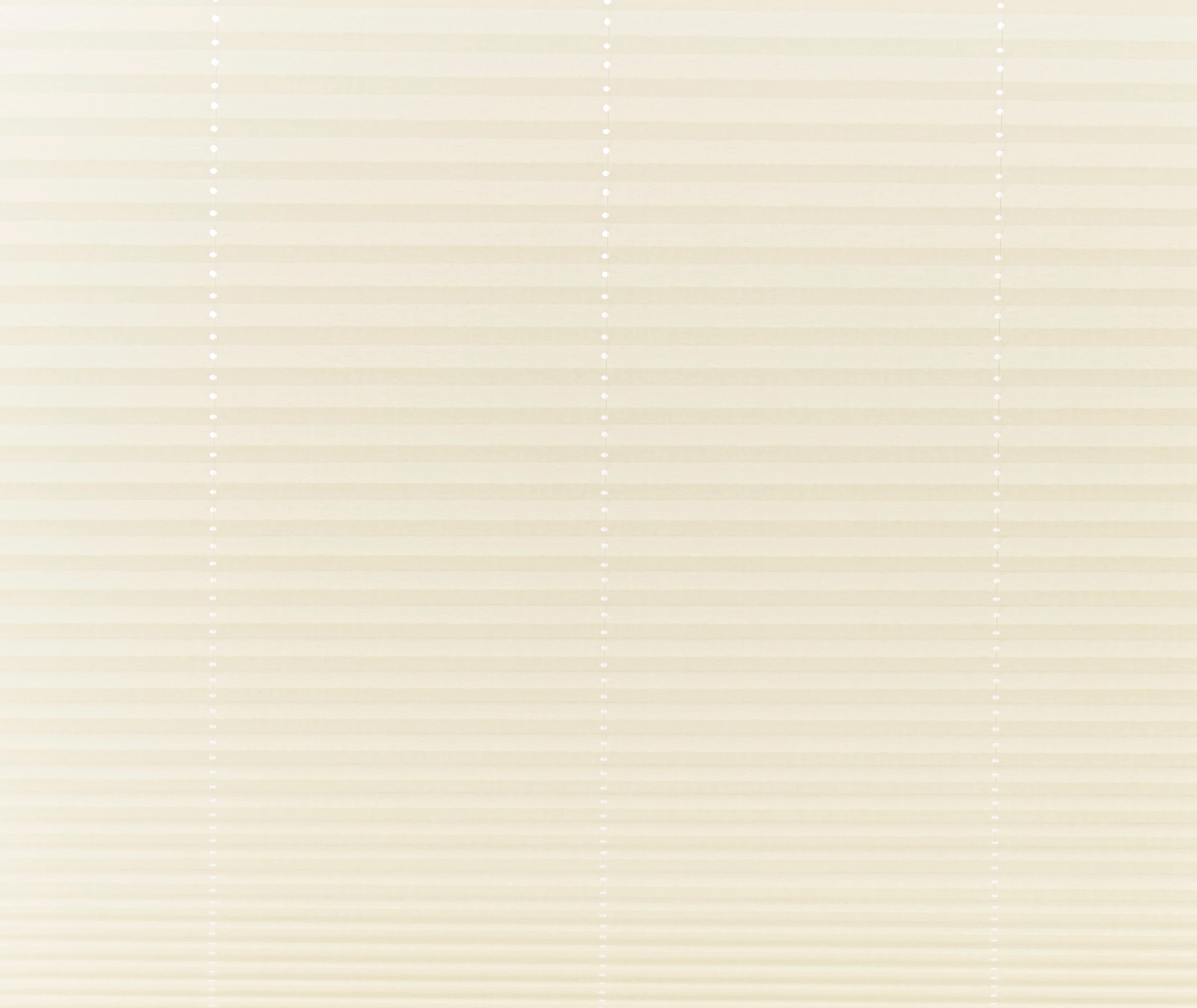 Beige pleated cellular shades covering a window, fully lowered and closed with vertical bead cords visible; filtering soft, diffused daylight into a neutral-toned interior, obscuring any outside view.