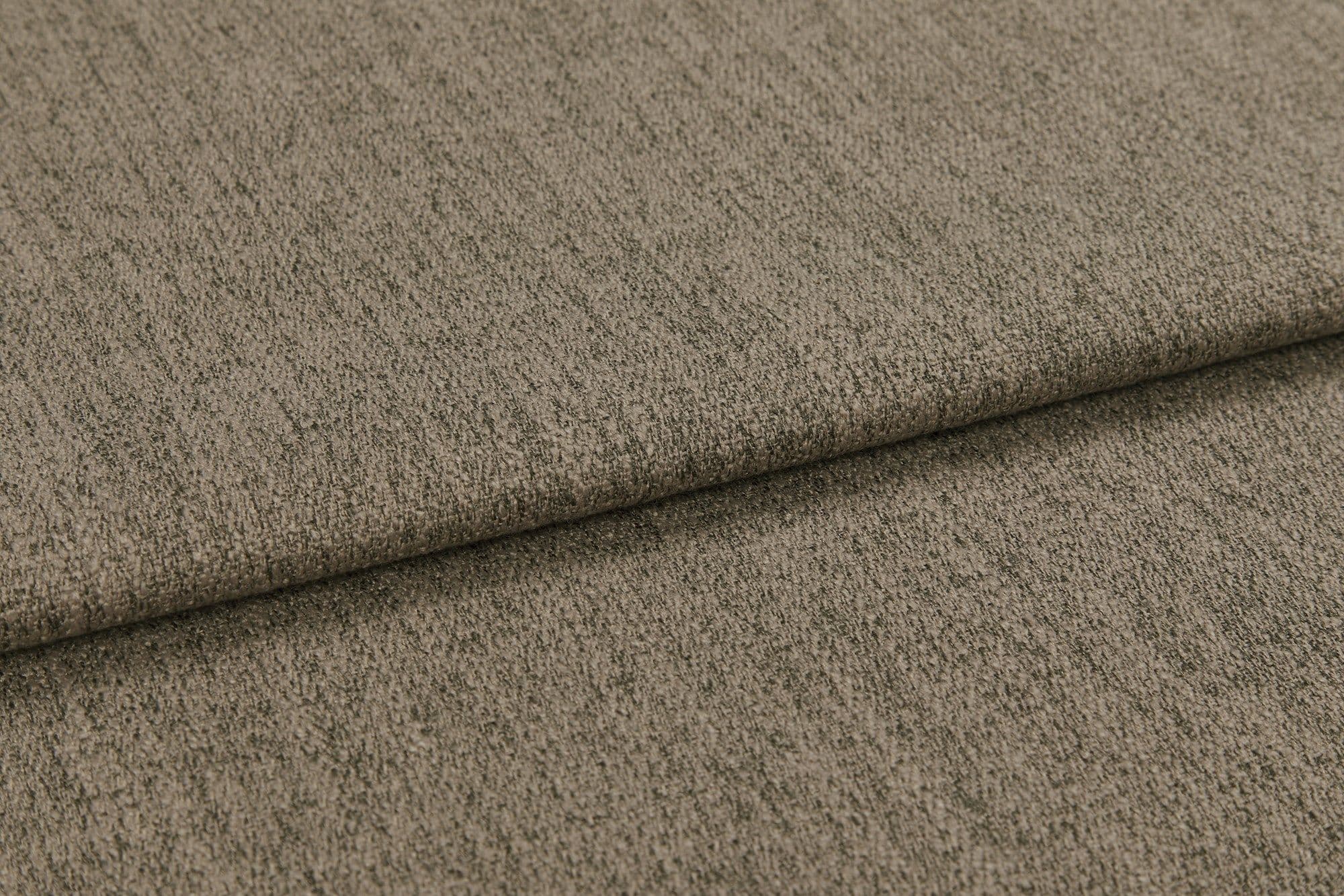 Textured taupe-brown upholstery fabric, folded once creating an overlap; fabric displays subtle vertical ribbing and short pile; close-up studio shot with soft, even lighting and neutral background.