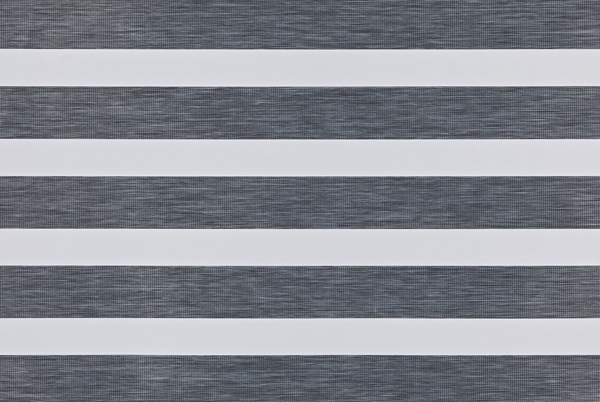 Zebra-style roller blind with alternating opaque white and semi-transparent dark-gray textured horizontal bands; bands aligned to create alternating blocked and filtered light; covers a window in a neutral, evenly lit interior.