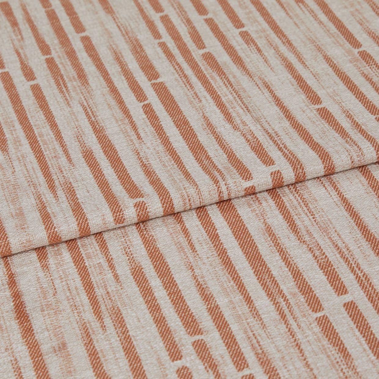 Textile fabric with rust-orange vertical dash pattern (linen-like texture), folded once so one panel overlaps another, displayed as a swatch under soft, even lighting â€” close-up, neutral background.